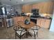 Spacious kitchen with wood cabinets, stainless steel appliances, and a round dining table with chairs at 605 Grassy Hill Rd, Summerville, SC 29483