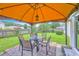 Covered patio featuring a brick floor and dining table set in a well-maintained backyard at 605 Grassy Hill Rd, Summerville, SC 29483