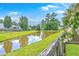 Scenic view of a community pond surrounded by lush greenery and well-kept lawns at 605 Grassy Hill Rd, Summerville, SC 29483