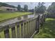 Picturesque backyard view with a pond and a rustic wooden fence in a lush setting at 605 Grassy Hill Rd, Summerville, SC 29483