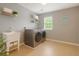 Well-lit laundry room featuring a utility sink, shelving, and modern washer and dryer at 708 Professor Dr, Ladson, SC 29456