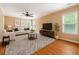 Inviting living room with hardwood floors, large windows, and comfortable seating is perfect for relaxation at 708 Professor Dr, Ladson, SC 29456