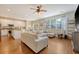 Bright living room boasts hardwood floors, ceiling fan, and sliding glass doors to the backyard at 708 Professor Dr, Ladson, SC 29456