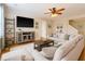 Bright living room featuring a sectional sofa, large TV, and a ceiling fan at 708 Professor Dr, Ladson, SC 29456