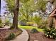 Spacious backyard with large trees, lush greenery and entertainment area at 8 Brisbane Dr, Charleston, SC 29407