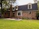 Brick house backyard featuring a well-maintained lawn, patio, and landscaping at 8 Brisbane Dr, Charleston, SC 29407