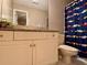 Well-lit bathroom with a sleek vanity, granite countertop, decorative mirror, and a car-themed shower curtain at 8 Brisbane Dr, Charleston, SC 29407