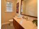 Bathroom with updated vanity, black and white tile floor, and natural light from the window at 8 Brisbane Dr, Charleston, SC 29407