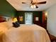 Spacious bedroom featuring a king-sized bed, green walls, and a ceiling fan at 8 Brisbane Dr, Charleston, SC 29407