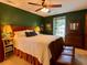 Spacious bedroom featuring a king-sized bed, green walls, and a ceiling fan at 8 Brisbane Dr, Charleston, SC 29407