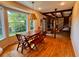 Bright dining area featuring hardwood floors, large windows, wooden table and bench at 8 Brisbane Dr, Charleston, SC 29407
