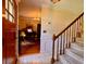 Foyer with a staircase leading upstairs and an entryway into the living room where a piano is at 8 Brisbane Dr, Charleston, SC 29407