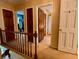 Upstairs hallway offering access to various rooms through wooden doors, with a view into a brightly lit bedroom adding depth at 8 Brisbane Dr, Charleston, SC 29407