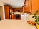 Kitchen with warm wood cabinets, white countertops, modern appliances, and hardwood floors at 8 Brisbane Dr, Charleston, SC 29407