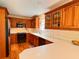 Well-lit kitchen featuring hardwood floors, wood cabinets, and modern appliances at 8 Brisbane Dr, Charleston, SC 29407