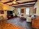Cozy living room with exposed beam ceiling, parquet floors, and neutral-colored furniture at 8 Brisbane Dr, Charleston, SC 29407