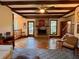 Spacious living area featuring a fireplace, staircase, and exposed beam ceiling at 8 Brisbane Dr, Charleston, SC 29407
