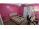 Bedroom features pink walls, wood floors, and a modern bed frame with headboard at 806 Greenmeadow Dr, Goose Creek, SC 29445