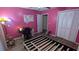 Bright bedroom features pink walls, wood floors, a desk area, and a large closet at 806 Greenmeadow Dr, Goose Creek, SC 29445