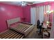 Bedroom features pink walls, wood floors, a modern bed frame, and curtains at 806 Greenmeadow Dr, Goose Creek, SC 29445