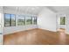 Bright bedroom with hardwood floors, vaulted ceilings, and expansive windows showcasing scenic views at 811 Treeloft Trce, Seabrook Island, SC 29455