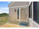 Cozy outdoor deck with wooden flooring, a sliding glass door, and serene views of nature at 811 Treeloft Trce, Seabrook Island, SC 29455
