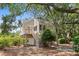 Inviting raised beach house with a charming staircase, set amidst mature trees and lush landscaping at 811 Treeloft Trce, Seabrook Island, SC 29455