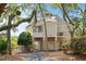 Charming raised beach house with stairs and under house access, set amidst trees and landscaping at 811 Treeloft Trce, Seabrook Island, SC 29455