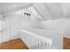 Second story hallway features hardwood floors and white railing, with natural light at 811 Treeloft Trce, Seabrook Island, SC 29455
