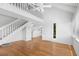 Bright, open living room with hardwood floors, white walls, and a vaulted ceiling with staircase access at 811 Treeloft Trce, Seabrook Island, SC 29455