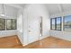 Sunlit room with hardwood floors, featuring expansive windows that frame a picturesque outdoor view at 811 Treeloft Trce, Seabrook Island, SC 29455