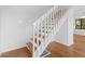 Hardwood staircase features white wooden banister and window, providing natural light at 811 Treeloft Trce, Seabrook Island, SC 29455