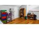 View of an organized attic space with storage shelves, drawers, and hardwood flooring at 8692 Bentwood Dr, North Charleston, SC 29406