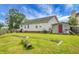 Wide shot of the backyard including grass, a storage shed and the back of the house at 8692 Bentwood Dr, North Charleston, SC 29406