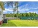 Spacious backyard featuring a lush lawn, a wooded fence, and an air conditioning unit at 8692 Bentwood Dr, North Charleston, SC 29406
