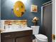 Stylish bathroom featuring blue walls, decorated mirror, vanity with modern sink and neutral-colored tiling at 8692 Bentwood Dr, North Charleston, SC 29406