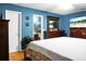 Spacious bedroom with wooden furniture and a serene blue color scheme at 8692 Bentwood Dr, North Charleston, SC 29406