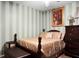 Bedroom with striped walls, a detailed comforter, and dark wood furniture at 8692 Bentwood Dr, North Charleston, SC 29406