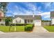 Cozy home with a tidy front yard, a porch with hanging baskets and a driveway leading to an attached garage at 8692 Bentwood Dr, North Charleston, SC 29406
