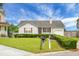 Well-maintained home with green lawn, cute front porch, and attached garage, mailbox in view at 8692 Bentwood Dr, North Charleston, SC 29406
