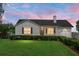 Charming single-story home with well-manicured lawn and inviting front porch with hanging flower baskets at 8692 Bentwood Dr, North Charleston, SC 29406