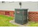 View of a Goodman HVAC unit located beside the home with red brick foundation and light gray siding at 8692 Bentwood Dr, North Charleston, SC 29406