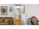 Interior shot of a hallway with hardwood floors, neutral walls, and decorative artwork at 8692 Bentwood Dr, North Charleston, SC 29406