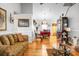 This living room has an open concept design that leads into the dining room with hardwood floors at 8692 Bentwood Dr, North Charleston, SC 29406