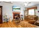 Living room with a fireplace, hardwood floors, neutral colors, and a ceiling fan at 8692 Bentwood Dr, North Charleston, SC 29406
