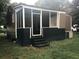 Back porch of home with open doorway, multiple windows, and black trim at 8930 Selah St, North Charleston, SC 29406