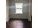 An empty room features hardwood floors and a large window at 8930 Selah St, North Charleston, SC 29406