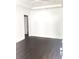 Open living room with hardwood floors, white trim, and a tray ceiling at 8930 Selah St, North Charleston, SC 29406