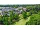 Scenic aerial view highlighting the community, pond, and lush greenery at 9049 Parlor Dr, Ladson, SC 29456