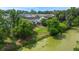 Aerial view of a backyard, enhanced by a serene pond and lush green trees at 9049 Parlor Dr, Ladson, SC 29456